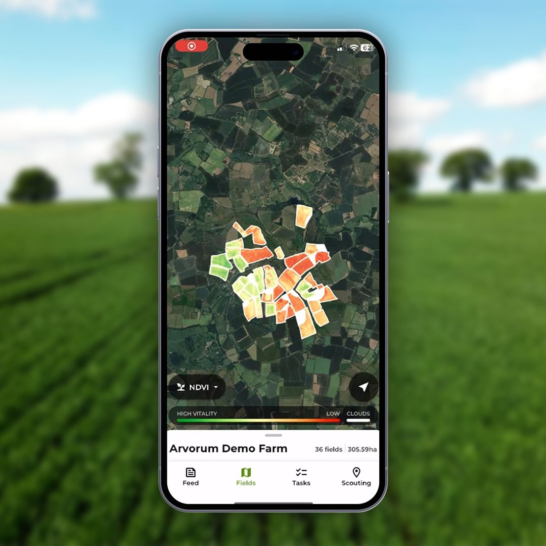 Picture of phone running precision farming app, Arvorum. Field in the background